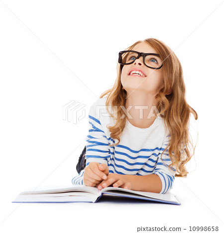 girl with book and eyeglasses lying on the floor girl with book and eyeglasses lying on the floor 10998658