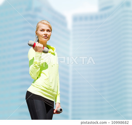sporty woman with light dumbbells outdoors sporty woman with light dumbbells outdoors 10998682