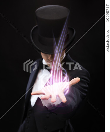 magician holding something on palm of his hand 10998757