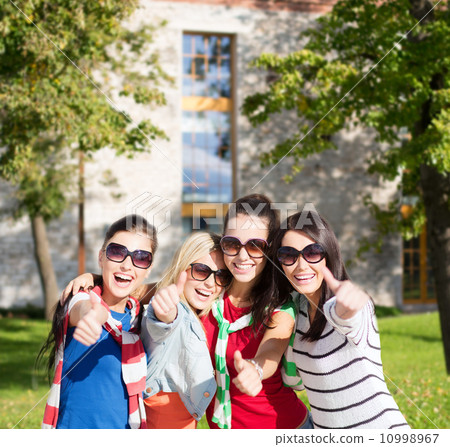 teenage girls or young women showing thumbs up teenage girls or young women showing thumbs up 10998967