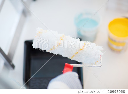 close up of male in gloves holding painting roller close up of male in gloves holding painting roller 10998968