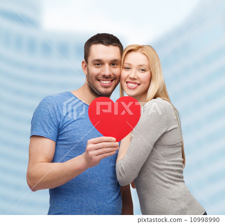 smiling couple holding big red heart 10998990