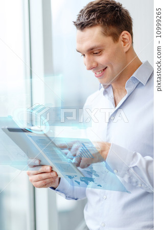 smiling businessman with tablet pc in office 10999265