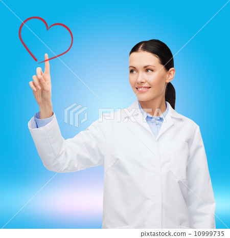 smiling female doctor pointing to heart smiling female doctor pointing to heart 10999735