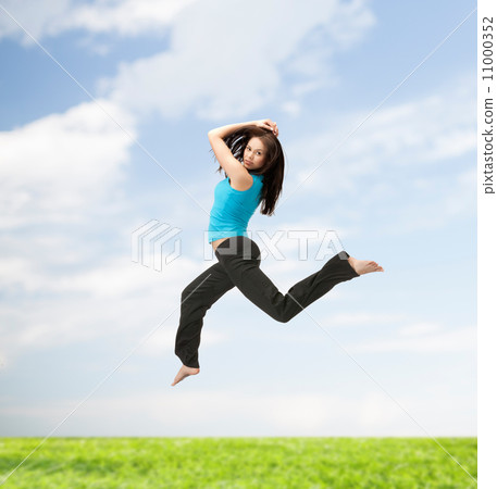 sporty woman jumping in sportswear 11000352