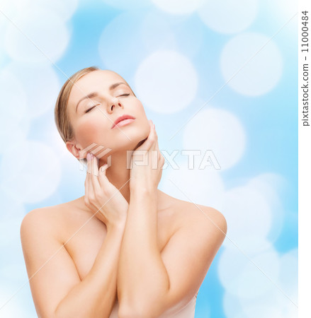 beautiful woman touching her face with closed eyes 11000484