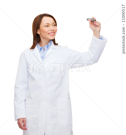 young female doctor writing something in the air young female doctor writing something in the air 11000517