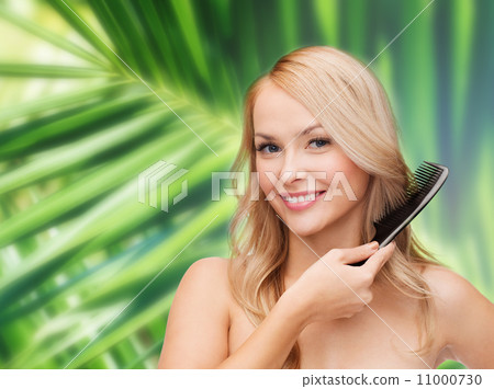 smiling woman with hair brush 11000730