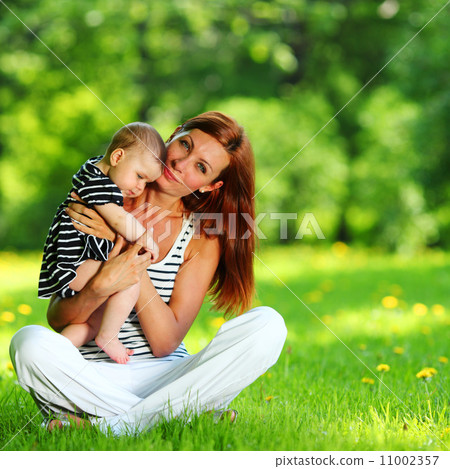 Mother and daughter on the green grass Mother and daughter on the green grass 11002357