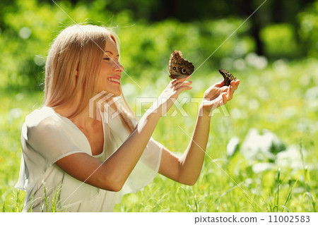 Woman playing with a butterfly Woman playing with a butterfly 11002583