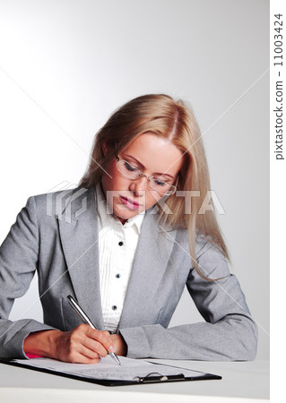 business woman writing in notebook 11003424