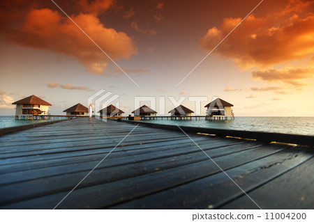 woman in a dress on maldivian sunset woman in a dress on maldivian sunset 11004200
