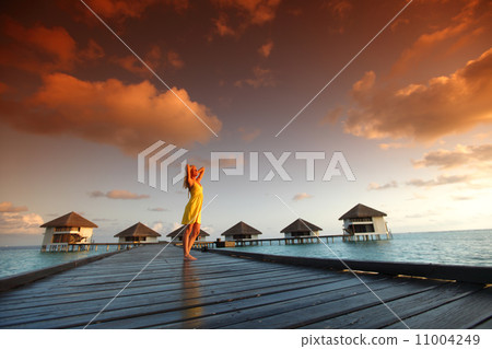 woman in a dress on maldivian sunset 11004249