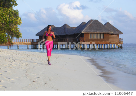 Woman running on beach Woman running on beach 11006447