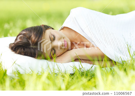 Woman sleeping on grass Woman sleeping on grass 11006567