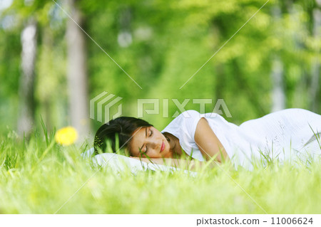 Woman sleeping on grass Woman sleeping on grass 11006624