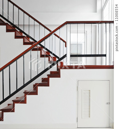 Storage room under wooden staircase 11008554