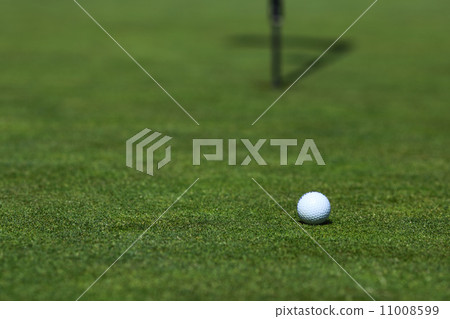 golf ball on lip of cup 11008599
