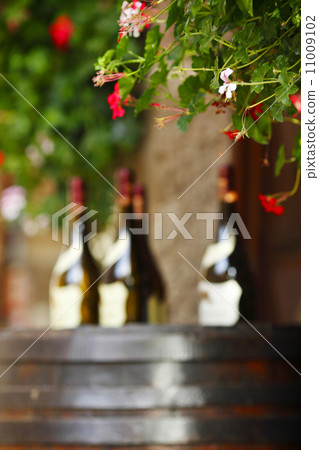 Wine bottles on wodden barrel 11009102