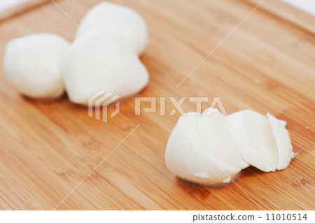 Sliced mozzarella on wooden board Sliced mozzarella on wooden board 11010514