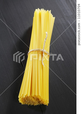 Raw pasta on black table 11010704