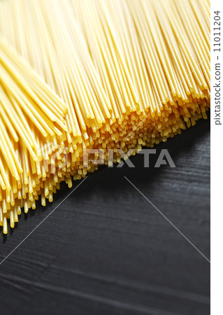 Raw pasta on black table 11011204