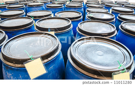 blue plastic industrial barrels for storage of chemicals in factory 11011280