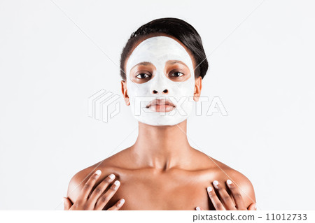 Beautiful African woman in Studio with facial mask Beautiful African woman in Studio with facial mask 11012733