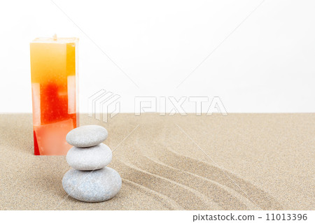 Balance zen stones and candle in sand on white Balance zen stones and candle in sand on white 11013396