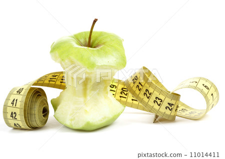 Green bitten apple isolated on white with measuring tape 11014411