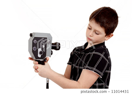 young boy with old vintage analog 8mm camera 11014431