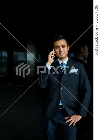 Confident businessman with phone 11017306