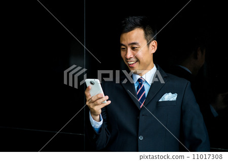 Confident businessman with phone 11017308