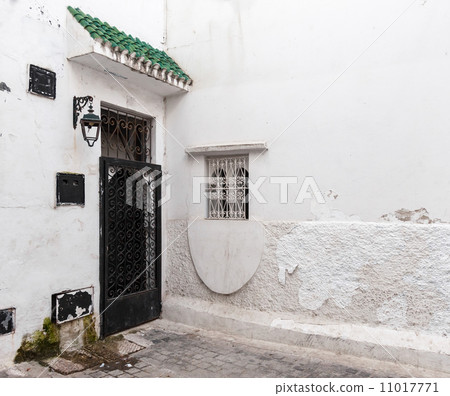 Locked door and white walls. Old Medina, historical part of Tang 11017771