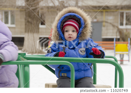 little girl with fear of riding on merry-go-round little girl with fear of riding on merry-go-round 11020749