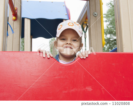 girl peeks out from behind shield playing on Playground girl peeks out from behind shield playing on Playground 11020808