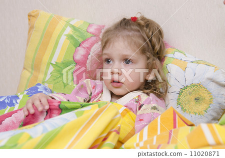 Two-year-old girl is in bed under the blanket Two-year-old girl is in bed under the blanket 11020871