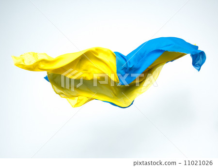 abstract pieces of blue and yellow fabric flying 11021026