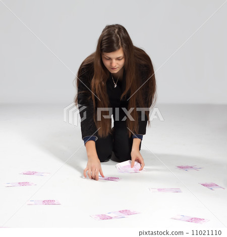 Young long-haired woman and money 11021110