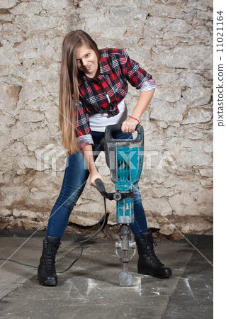 Young long-haired woman with a jackhammer 11021164