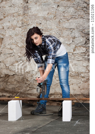 Young long-haired woman with an angle grinder Young long-haired woman with an angle grinder 11021166