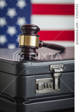 Briefcase and Gavel Resting on Table with American Flag Behind 11022591