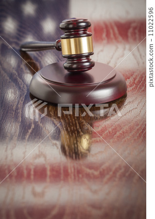 Wooden Gavel Resting on Flag Reflecting Table Wooden Gavel Resting on Flag Reflecting Table 11022596
