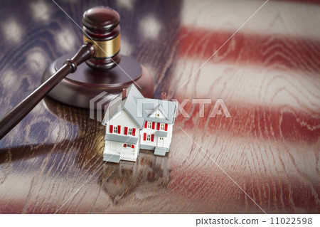 Small House and Gavel on Table with American Flag Reflection Small House and Gavel on Table with American Flag Reflection 11022598