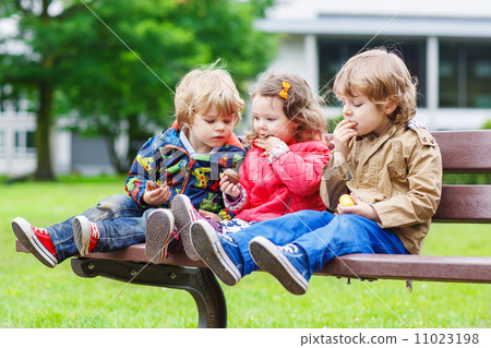 Two little brothers and sister having fun in park. 11023198
