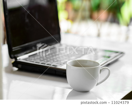 Coffee cup and laptop for business, Selective focus on coffee. 11024379
