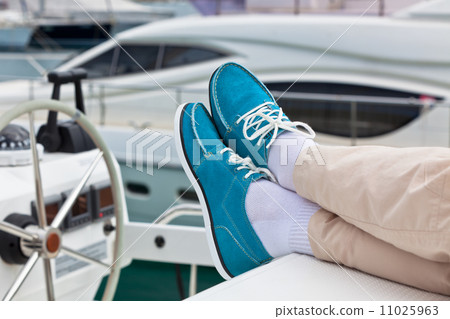 Legs in pants and bright blue topsiders on yacht Legs in pants and bright blue topsiders on yacht 11025963