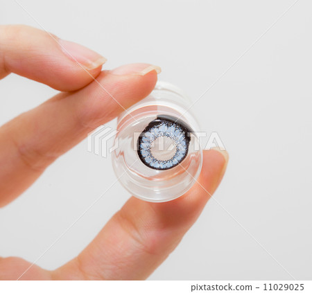 cosmetic contact lenses in bottle with  hand 11029025