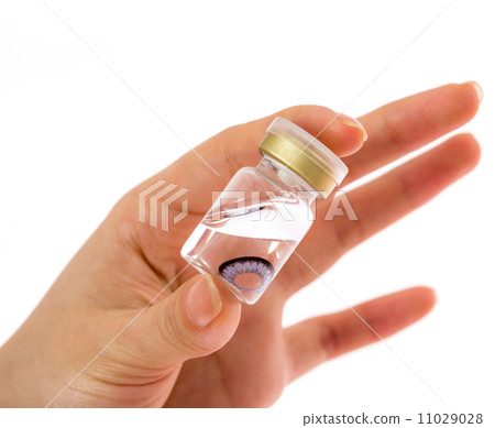 cosmetic contact lenses in bottle with  hand 11029028