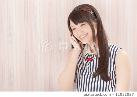 Pretty school girls talking happily on the smartphone in the room Pretty school girls talking happily on the smartphone in the room 11031087